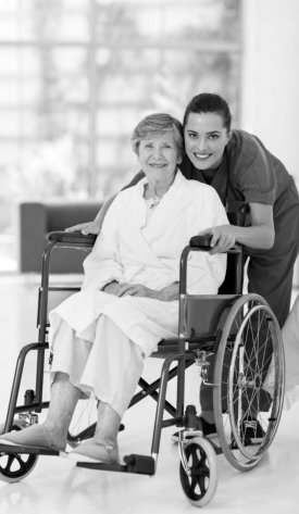 nurse together with her happy patient on wheelchair