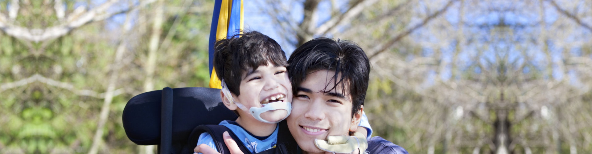 portrait of kid with disability and young man